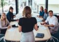 A group of people sitting around a table Description automatically generated with medium confidence