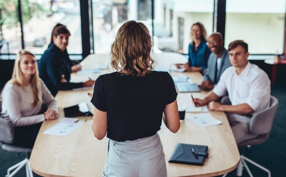 A group of people sitting around a table Description automatically generated with medium confidence