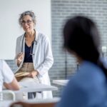 A person talking to a group of people Description automatically generated with medium confidence