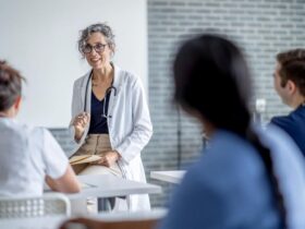 A person talking to a group of people Description automatically generated with medium confidence