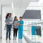 A group of people walking in a hallway Description automatically generated