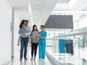 A group of people walking in a hallway Description automatically generated