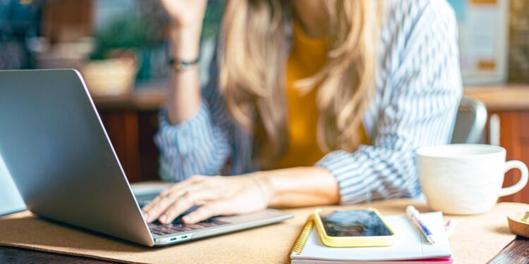 A person working on her computer Description automatically generated with medium confidence
