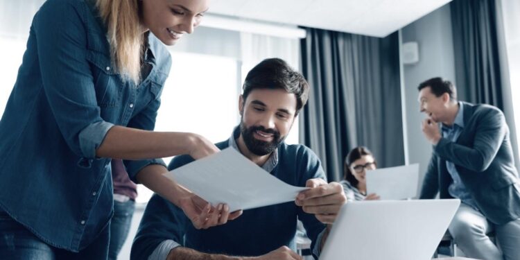 A person showing a person something on the computer Description automatically generated with medium confidence