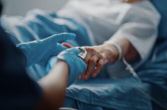 A picture containing person, indoor, bed, hospital room Description automatically generated