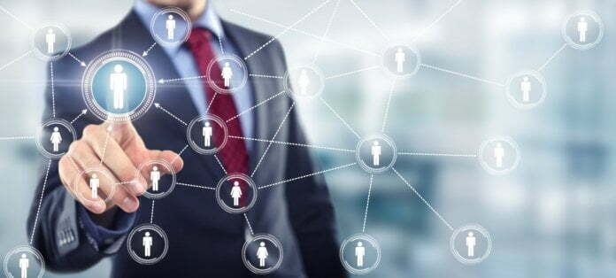 Man in office touching screen Network