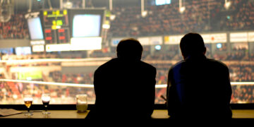 A couple of people sitting at a table Description automatically generated