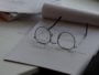 black framed eyeglasses on top of white printing paper